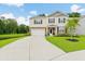 Charming two-story home with a well-manicured lawn and a long driveway leading to the garage at 217 Black Tupelo Ct, Moncks Corner, SC 29461