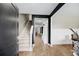Spacious foyer with stairs, coat rack, and stylish decor with dark accent wall at 217 Black Tupelo Ct, Moncks Corner, SC 29461