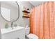 Bright bathroom features decor shelves and a modern sink with an orange patterned shower curtain at 2226 Arthur Rose Ln, Johns Island, SC 29455