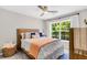 Comfortable bedroom with large window, neutral walls and natural wood furniture at 2226 Arthur Rose Ln, Johns Island, SC 29455