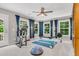 Bonus room features natural light from multiple windows, fitness equipment and gray carpeting at 2226 Arthur Rose Ln, Johns Island, SC 29455