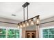 Modern chandelier over large window with scenic views and natural light at 2226 Arthur Rose Ln, Johns Island, SC 29455