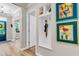 Hallway view with built-in storage, decorative artwork, and a view of the front door at 2226 Arthur Rose Ln, Johns Island, SC 29455