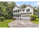 Beautiful two-story home with a double porch, a two-car garage, and a well-manicured front lawn and rock driveway at 2226 Arthur Rose Ln, Johns Island, SC 29455