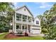 Striking two-story white home with double porches and a well-kept yard, perfect for curb appeal at 2226 Arthur Rose Ln, Johns Island, SC 29455