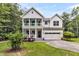 Charming two-story white home featuring a double porch, attached garage, and a well-maintained lawn at 2226 Arthur Rose Ln, Johns Island, SC 29455
