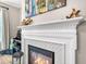 Close-up of fireplace with decorative tile surround, mantel, and accessories at 2226 Arthur Rose Ln, Johns Island, SC 29455