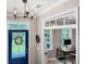Welcoming foyer with modern lighting, a blue front door, and a view of a home office space at 2226 Arthur Rose Ln, Johns Island, SC 29455