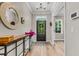 Bright foyer featuring a round mirror, console table with flowers, and a stylish rug at the entrance at 2226 Arthur Rose Ln, Johns Island, SC 29455
