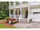 Inviting front porch with white railings, flower boxes, and a cozy seating area leading to the front door at 2226 Arthur Rose Ln, Johns Island, SC 29455