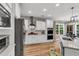 Modern kitchen with stainless steel appliances, island with seating, and stylish light fixtures at 2226 Arthur Rose Ln, Johns Island, SC 29455