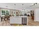 Bright open-concept kitchen with a large island, stainless steel appliances, and seamless flow into the dining and living areas at 2226 Arthur Rose Ln, Johns Island, SC 29455