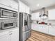 Modern kitchen featuring stainless steel appliances, white cabinetry, granite countertops, and ample storage space at 2226 Arthur Rose Ln, Johns Island, SC 29455