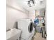 Functional laundry room with front load washer and dryer, sink and storage shelving at 2226 Arthur Rose Ln, Johns Island, SC 29455