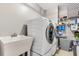 Modern laundry room with sink, washer, dryer, shelving and accent pieces at 2226 Arthur Rose Ln, Johns Island, SC 29455
