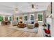 Spacious open-concept living room with many windows, fireplace, dining area, and hardwood floors at 2226 Arthur Rose Ln, Johns Island, SC 29455