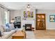 Cozy living room with a fireplace, piano, and built-in display case with bright, natural lighting at 2226 Arthur Rose Ln, Johns Island, SC 29455