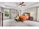 Tranquil bedroom with tray ceiling, ceiling fan, neutral colors, and large windows offering plenty of natural light at 2226 Arthur Rose Ln, Johns Island, SC 29455