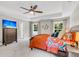 Bright main bedroom featuring a tray ceiling, ceiling fan, TV, and two large windows at 2226 Arthur Rose Ln, Johns Island, SC 29455
