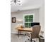 Bright office space with a wooden desk, comfortable chair, and a large window overlooking greenery at 2226 Arthur Rose Ln, Johns Island, SC 29455