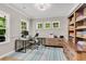 Bright home office featuring built-in shelving, modern desk, neutral paint, and a striped rug at 2226 Arthur Rose Ln, Johns Island, SC 29455