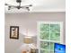 Office features natural light, a playful cartoon art piece, and a striped lamp at 2226 Arthur Rose Ln, Johns Island, SC 29455