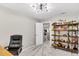 Spacious office with unique lighting, storage shelves filled with toys, and gray carpeting at 2226 Arthur Rose Ln, Johns Island, SC 29455