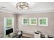 Bright office with three windows showing views of trees, a modern desk, and neutral paint at 2226 Arthur Rose Ln, Johns Island, SC 29455