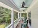 Relaxing covered porch with ceiling fans, comfortable chairs and views of the surrounding lush trees at 2226 Arthur Rose Ln, Johns Island, SC 29455