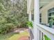 Inviting porch view showcasing its charming design, from the railing to the lovely natural scenery at 2226 Arthur Rose Ln, Johns Island, SC 29455