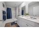 Bright bathroom features double sink vanity, wood-look floor, white cabinets and shower with blue accents at 225 N Light Way, Summerville, SC 29486
