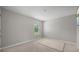 Bright bedroom with neutral carpet, gray walls, base molding, and natural light from a window at 225 N Light Way, Summerville, SC 29486