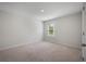 Neutral bedroom with carpet, light-colored walls, natural light from window, and simple clean aesthetic at 225 N Light Way, Summerville, SC 29486