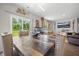 Bright dining room with hardwood floors, modern lighting, and large sliding glass doors to the backyard at 225 N Light Way, Summerville, SC 29486