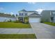 Beautiful two-story home boasts a yellow front door, manicured lawn, and a two-car garage at 225 N Light Way, Summerville, SC 29486