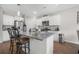 Well-lit kitchen featuring white cabinets, stainless steel appliances, and a granite countertop island with seating at 225 N Light Way, Summerville, SC 29486