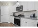 Modern kitchen featuring stainless steel appliances, granite countertops, and white cabinets at 225 N Light Way, Summerville, SC 29486