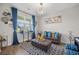 Stylish living room with a comfortable leather sofa, modern decor, and plenty of natural light at 225 N Light Way, Summerville, SC 29486