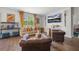 Open-concept living room featuring hardwood floors, a decorative fireplace, and large windows at 225 N Light Way, Summerville, SC 29486