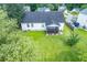 Aerial view of a large backyard with a green lawn, patio, and landscaping at 229 Lindy Creek Rd, Goose Creek, SC 29445