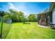 Spacious backyard featuring lush green grass, a fire pit, and a screened-in porch at 229 Lindy Creek Rd, Goose Creek, SC 29445
