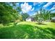 Expansive backyard with a screened porch, lush lawn, and mature trees provides privacy at 229 Lindy Creek Rd, Goose Creek, SC 29445