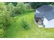 Expansive backyard with lush green lawn, a fire pit, and a screened porch, perfect for outdoor gatherings and relaxation at 229 Lindy Creek Rd, Goose Creek, SC 29445