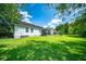 Lush backyard view featuring manicured lawn, mature trees, and screened-in porch at 229 Lindy Creek Rd, Goose Creek, SC 29445