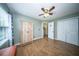 A cozy bedroom features a ceiling fan, wood floors, and a spacious closet at 229 Lindy Creek Rd, Goose Creek, SC 29445