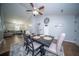 Formal dining room with neutral colors, ceiling fan, and open concept to living area at 229 Lindy Creek Rd, Goose Creek, SC 29445