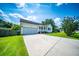 Inviting single-story home with a cozy front porch and an attached garage, complemented by a spacious driveway at 229 Lindy Creek Rd, Goose Creek, SC 29445