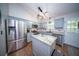 Charming kitchen features stainless appliances, granite counters, ample cabinet space, and island at 229 Lindy Creek Rd, Goose Creek, SC 29445