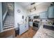 Bright kitchen with an island, granite countertops, modern appliances, and a view of the stairway at 229 Lindy Creek Rd, Goose Creek, SC 29445