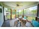 Relaxing screened porch features comfortable seating and view of lush backyard at 229 Lindy Creek Rd, Goose Creek, SC 29445